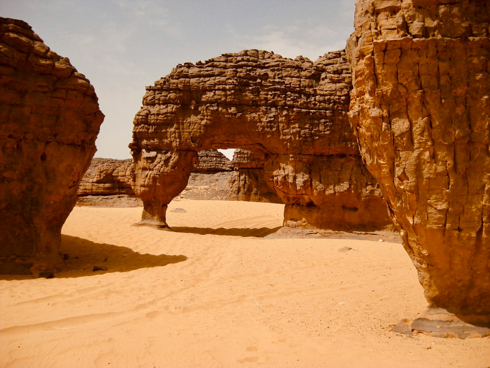 A natural sandstone arch in the Tassili du Hoggar desert, Algeria