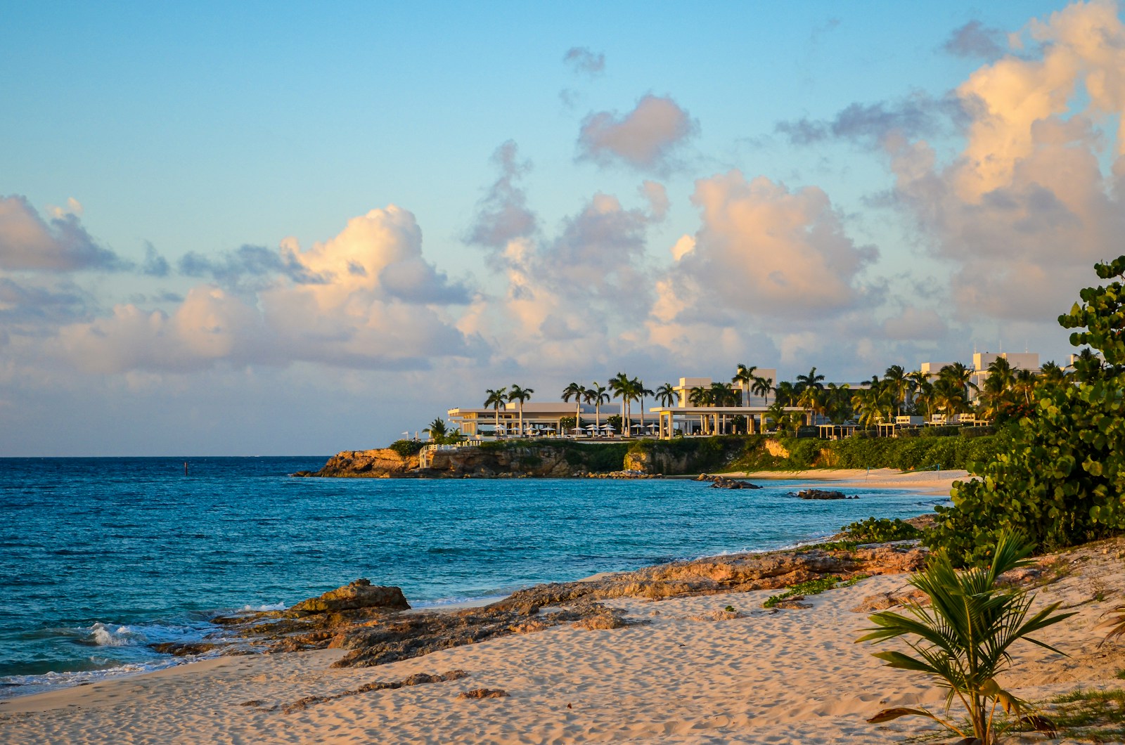 A turquoise bay and white sand beach with a low headland at Barnes Bay, Anguilla