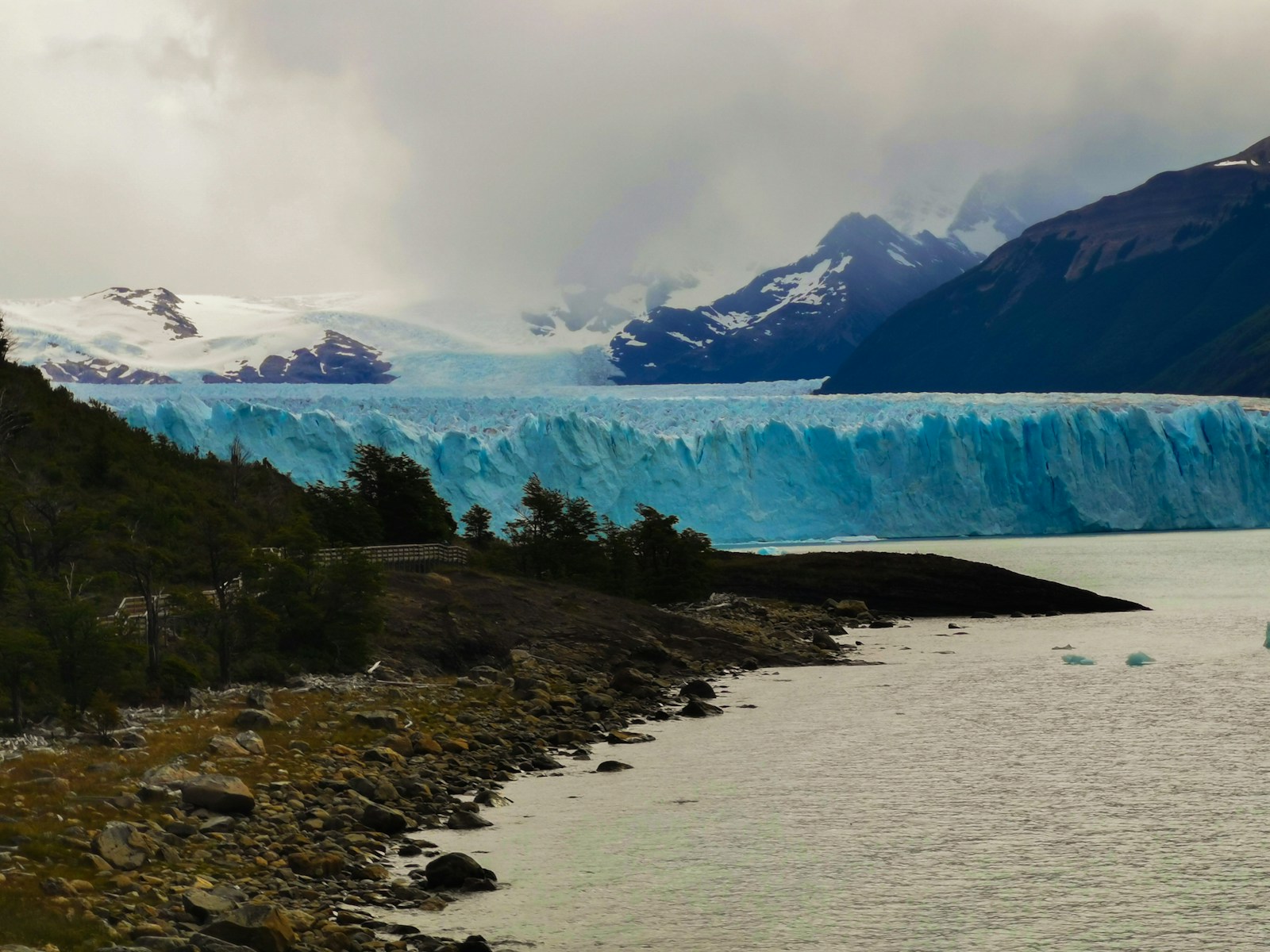 The blue wall of the Perito Moreno glacier below the Andes in Patagonia