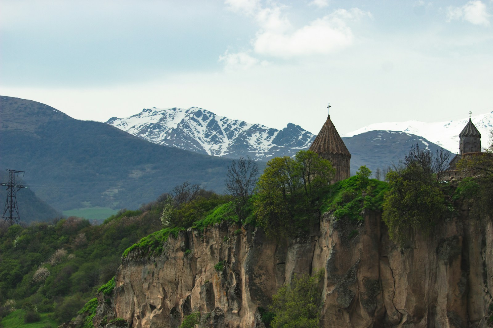 The medieval Tatev monastery on its clifftop with the Caucasus mountains behind