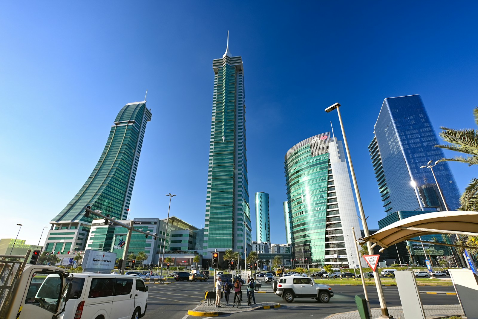 The curved twin towers of the Bahrain Financial Harbour against a bright blue sky, Manama