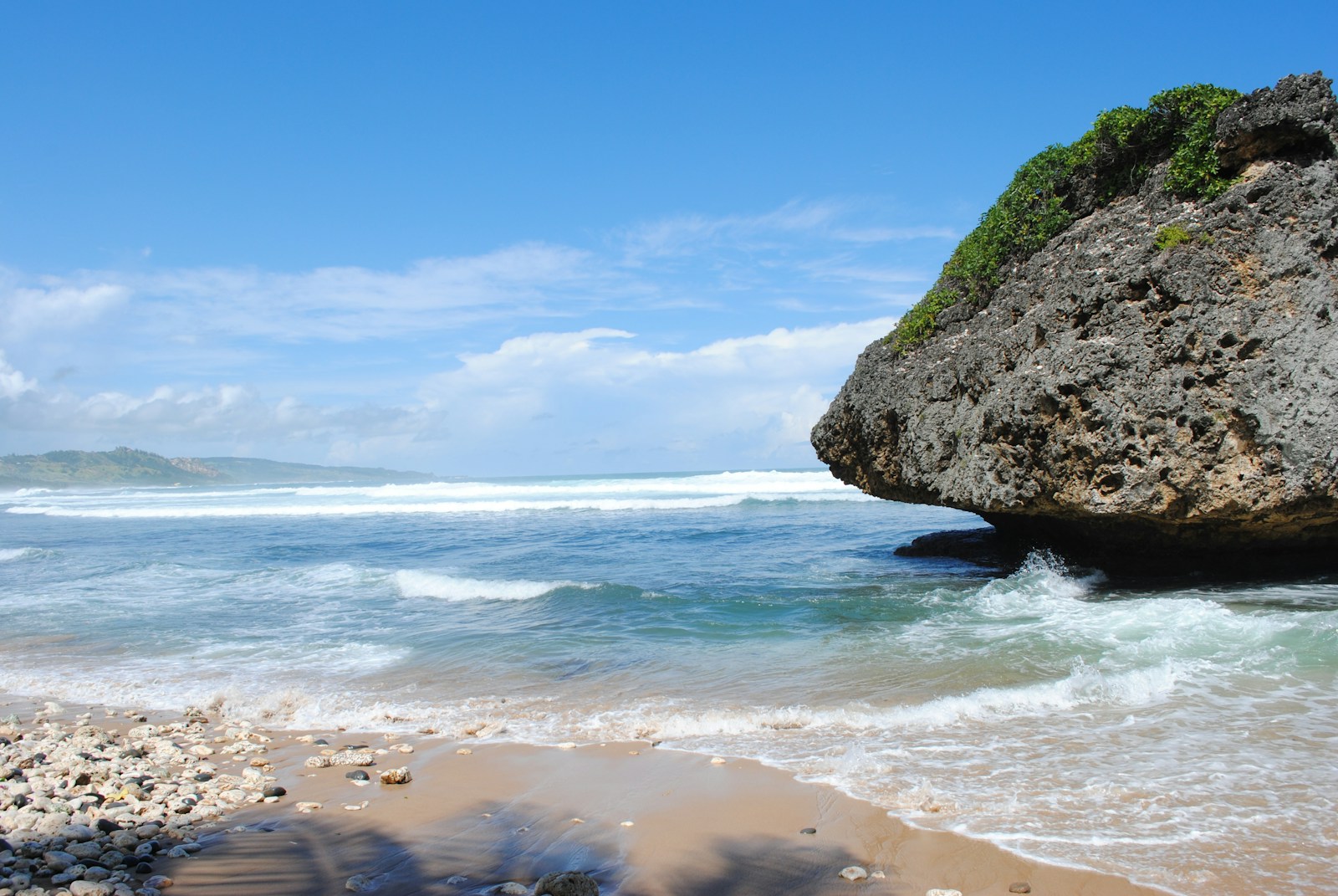 The famous mushroom-shaped coral boulder standing in the surf at Bathsheba, Barbados