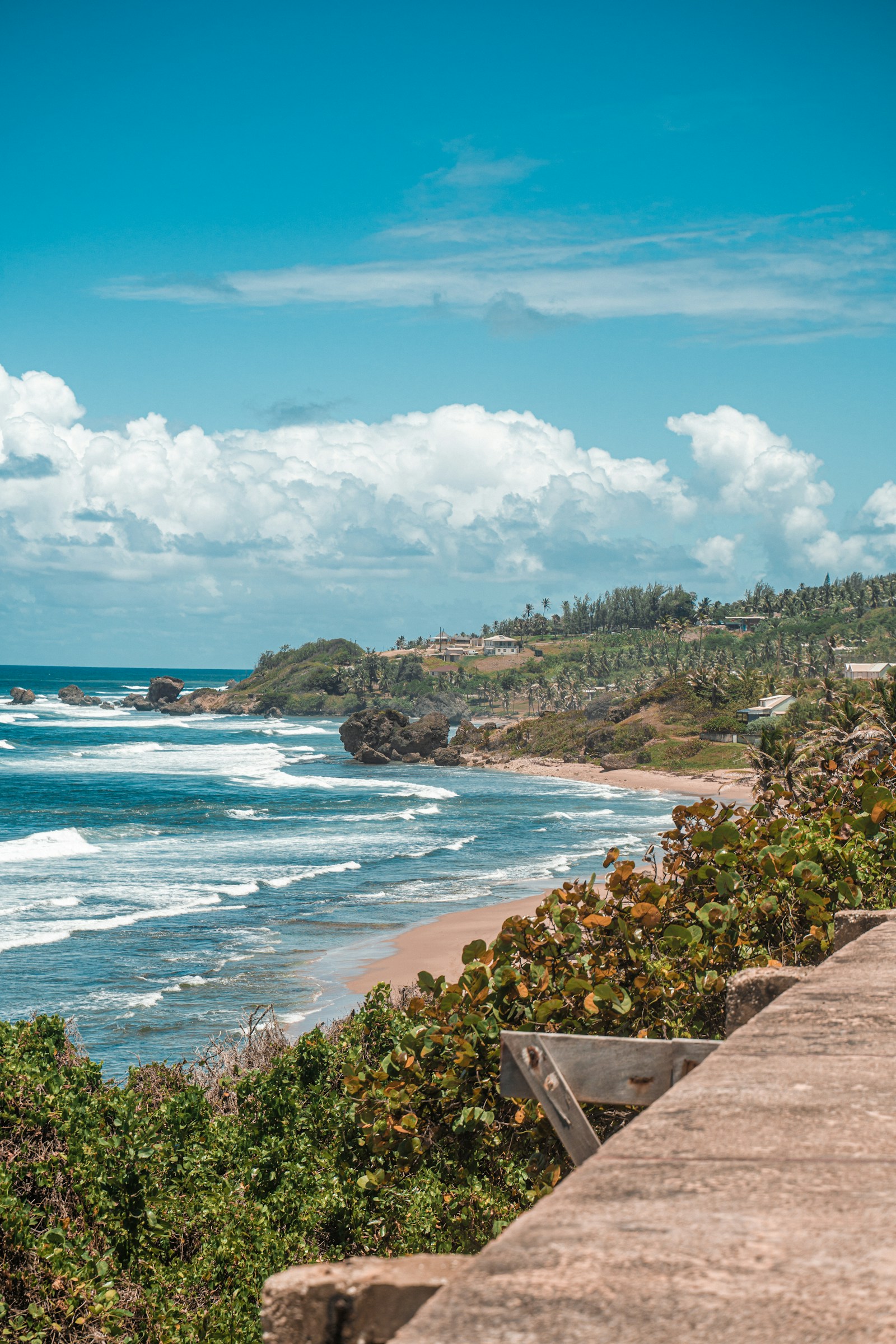 The rugged Bathsheba coast on the Atlantic east side of Barbados, with boulders, surf, and green hills