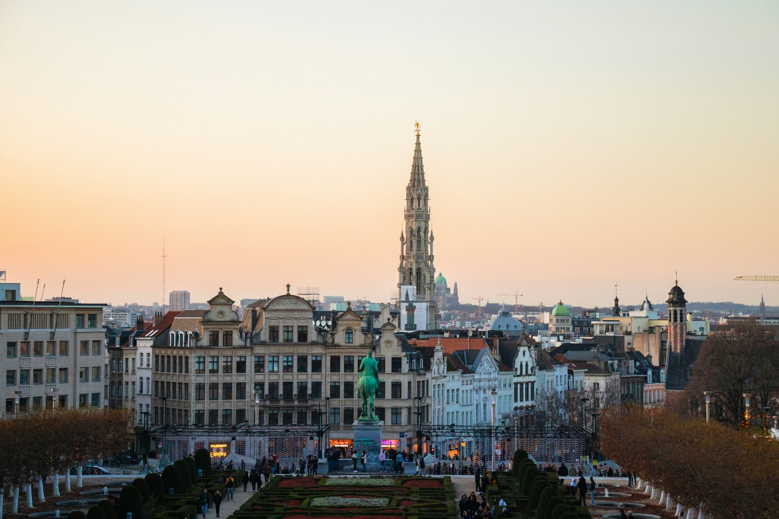 The Gothic spire of the Brussels Town Hall over the city at sunset