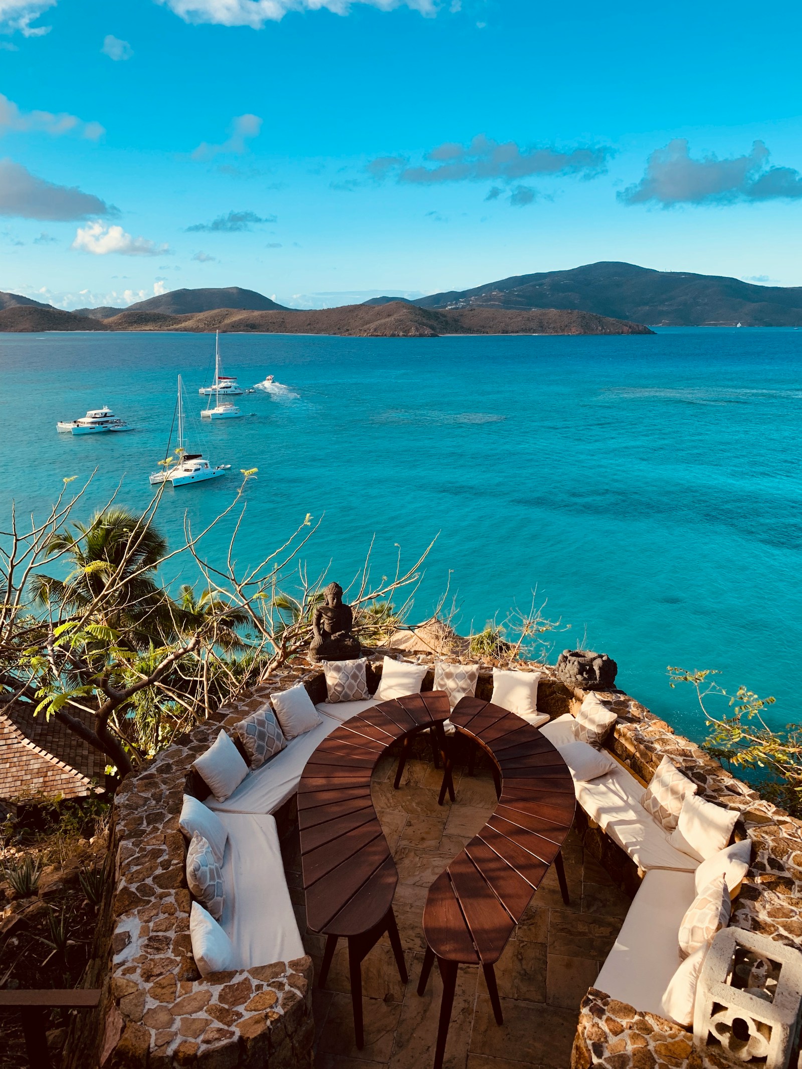 A clifftop terrace overlooking a turquoise bay full of yachts, British Virgin Islands