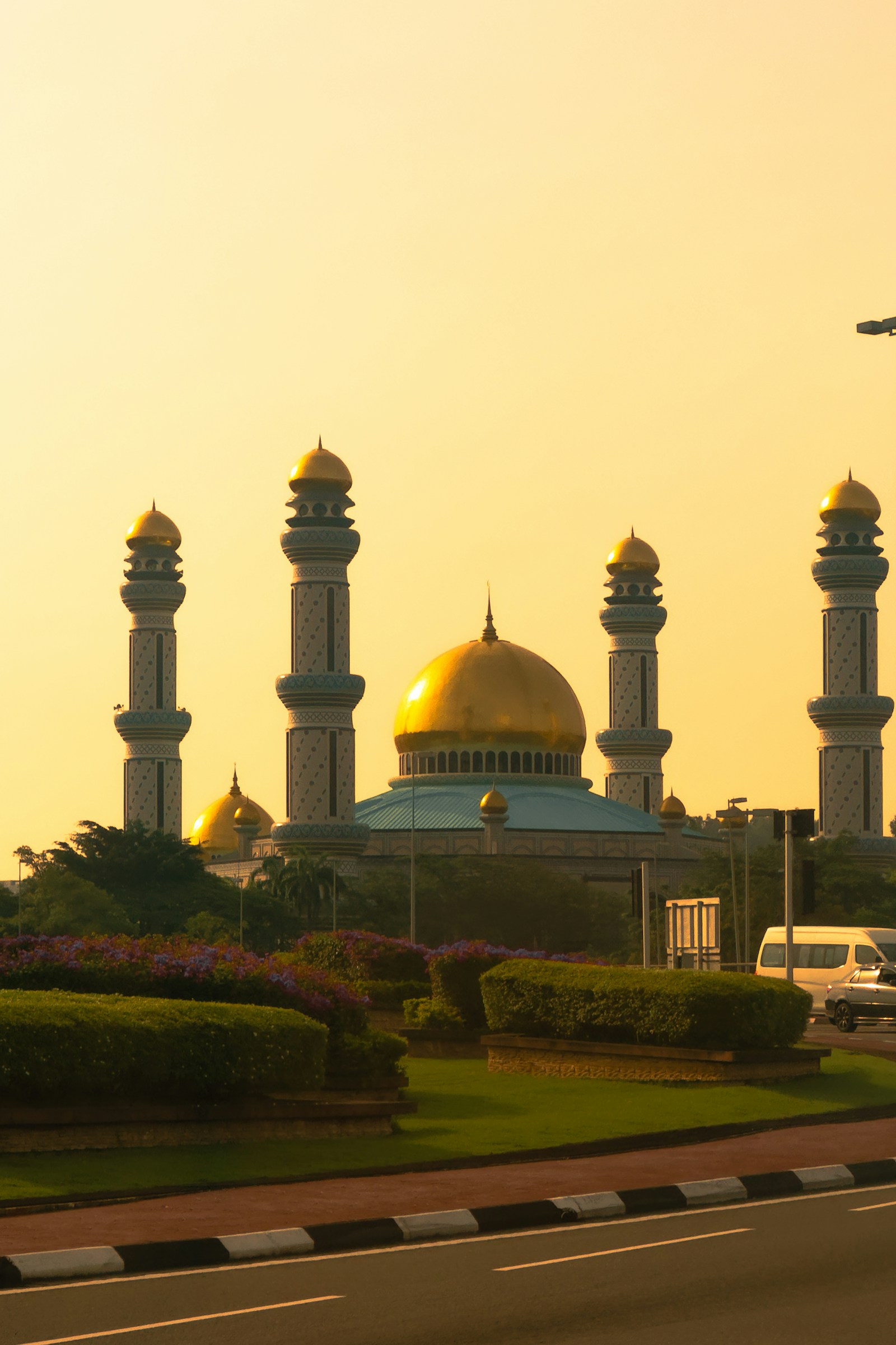 The golden domes and minarets of the Jame' Asr Hassanil Bolkiah Mosque at golden hour, Brunei