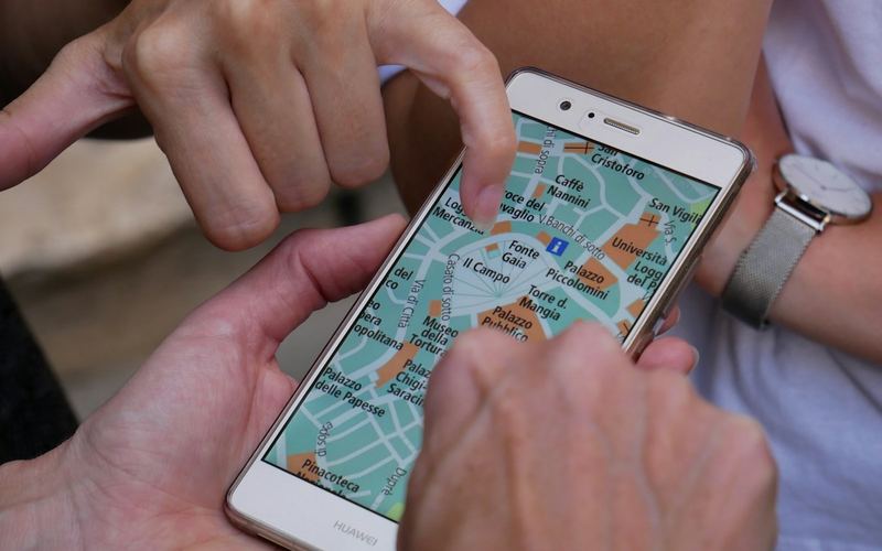 Hands using a map app on a phone