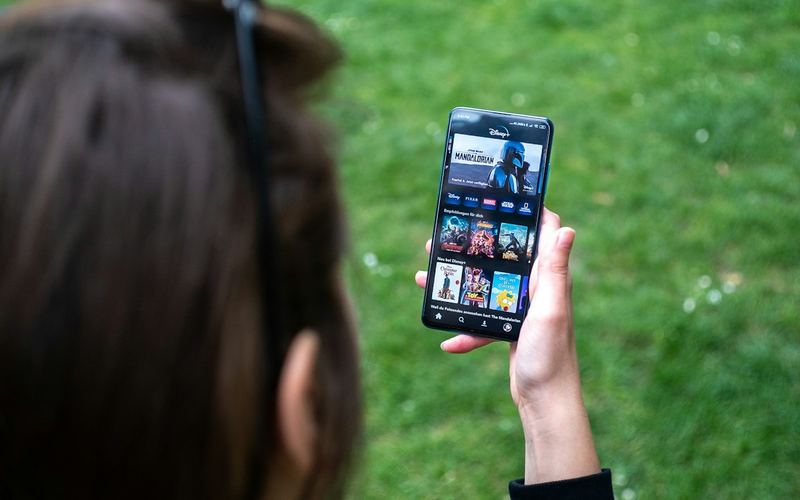 Someone streaming video on a phone outdoors