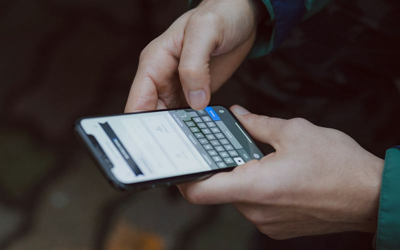 Hands typing a message on a phone