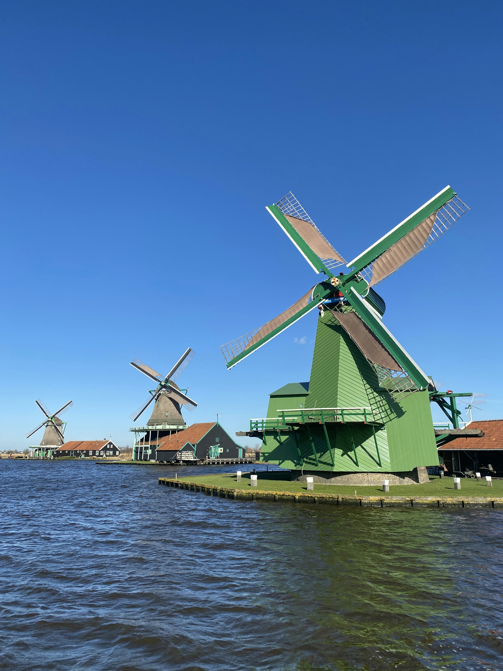 A row of traditional windmills at Zaanse Schans in the Netherlands