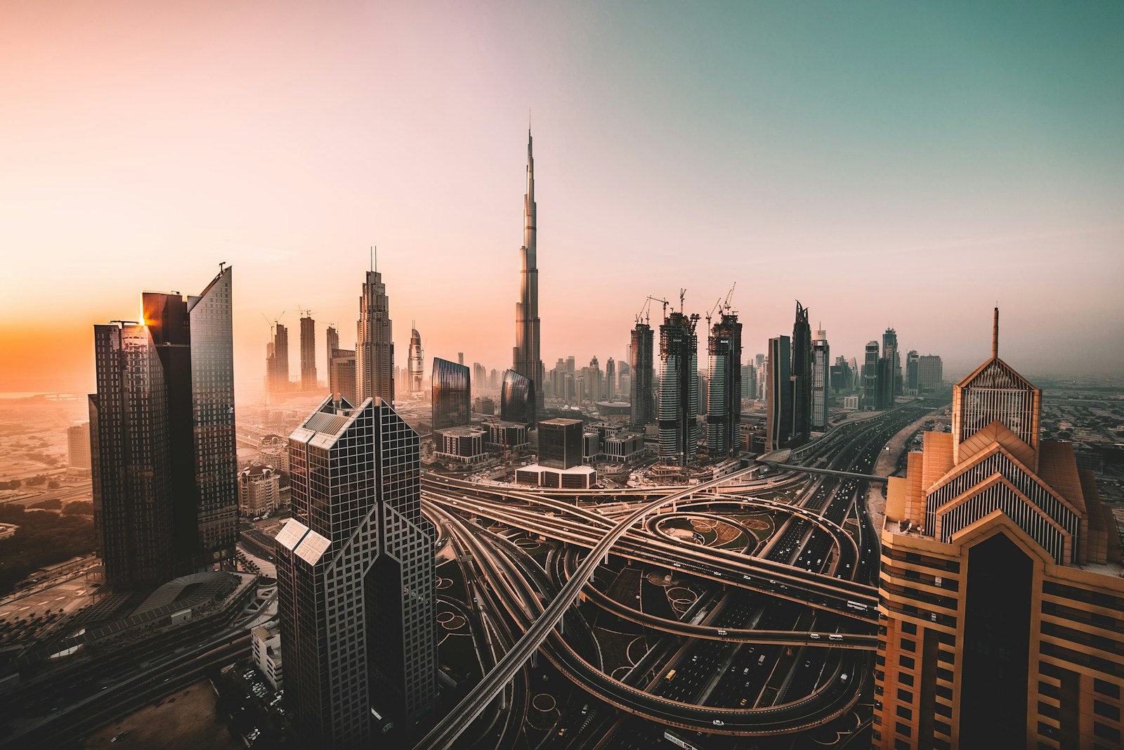 The Burj Khalifa and skyscrapers above a highway interchange in Dubai