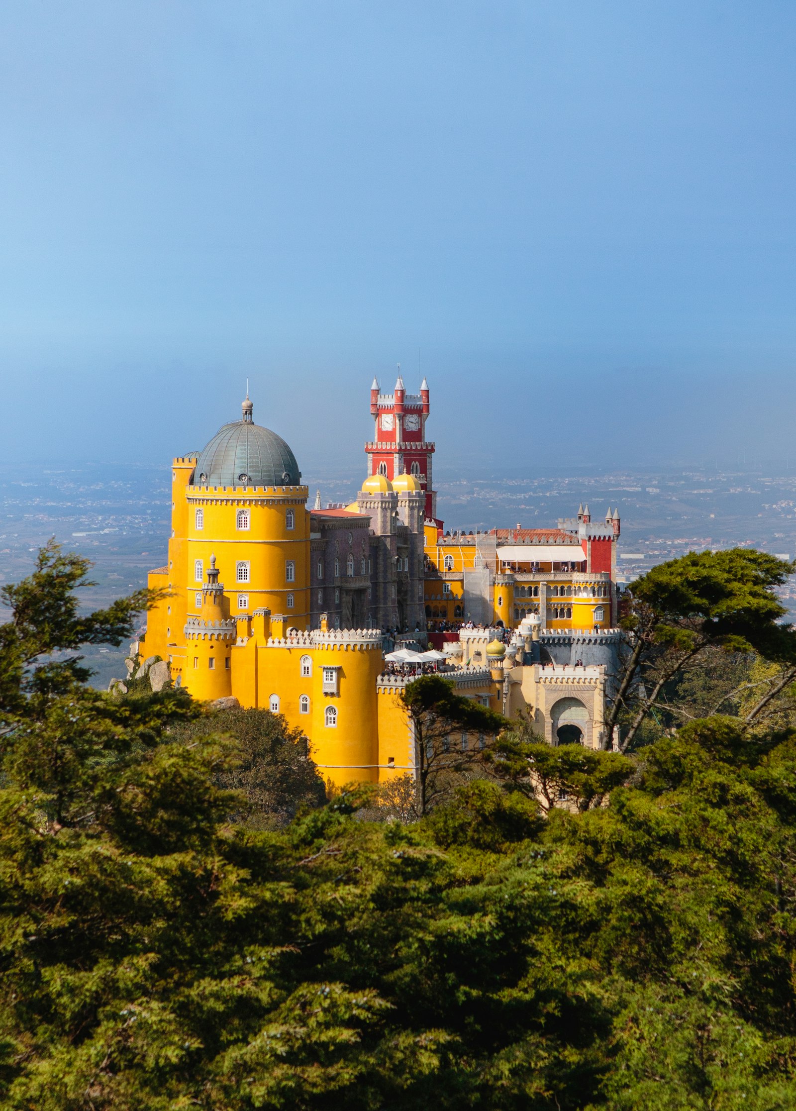 The colourful Pena Palace on a green hillside in Sintra, Portugal