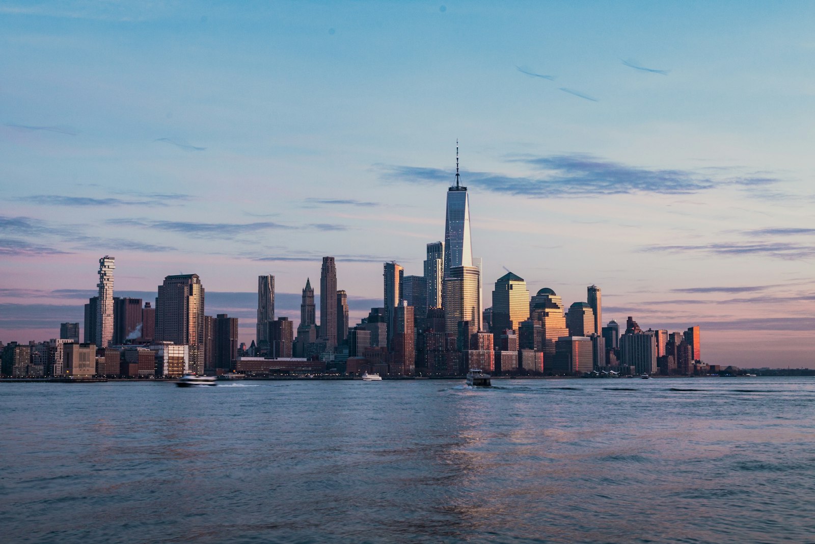 The New York City skyline across the water at golden hour