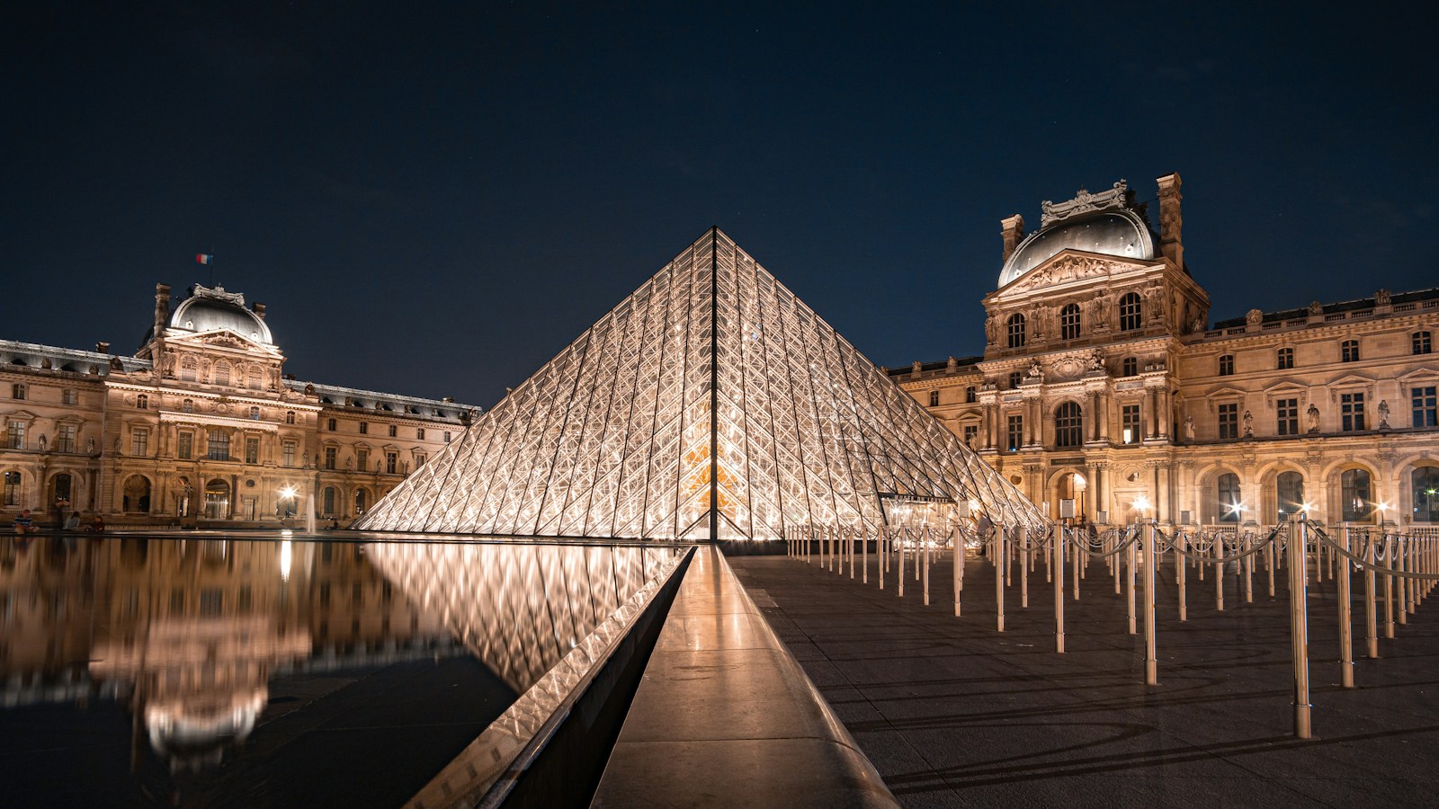 The Louvre pyramid lit at night