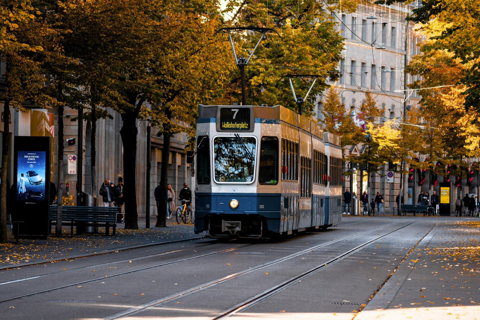 A blue and white tram on a Zurich street