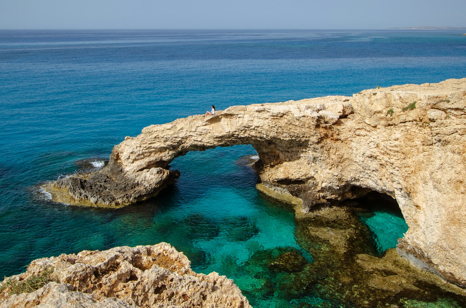The natural rock sea arch over brilliant turquoise water at Cape Greco near Ayia Napa