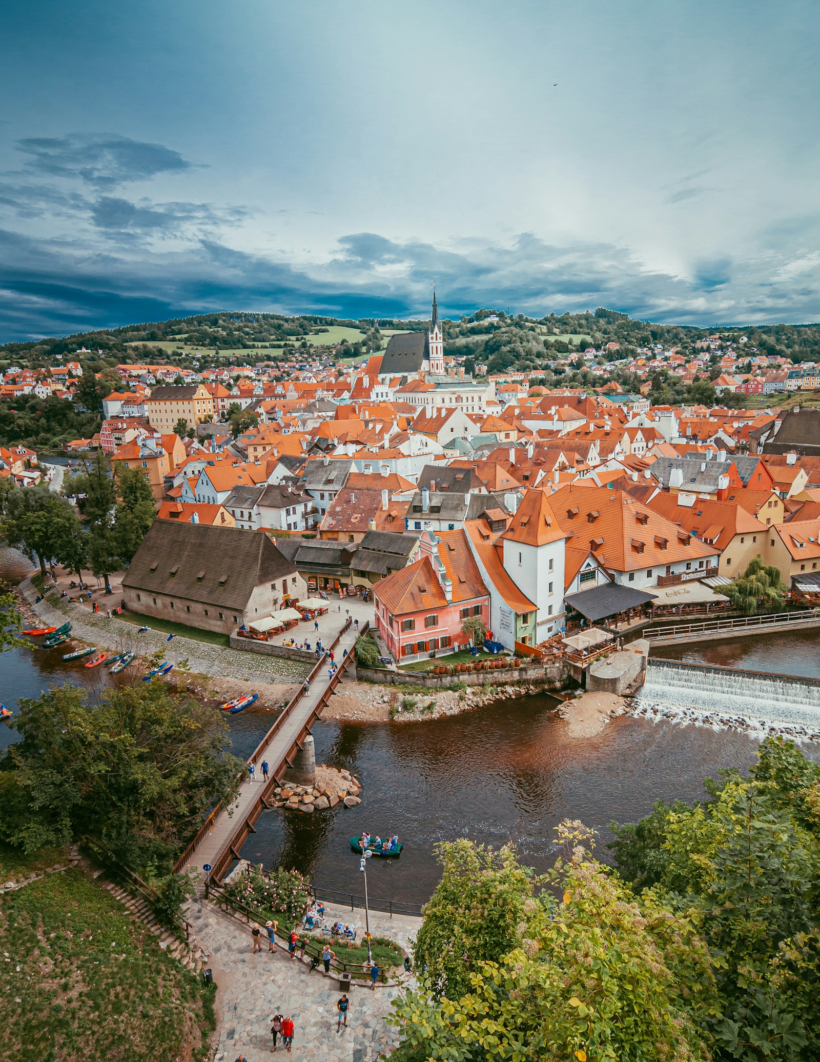 The red rooftops and castle tower of the medieval town of Cesky Krumlov above a bend in the Vltava river