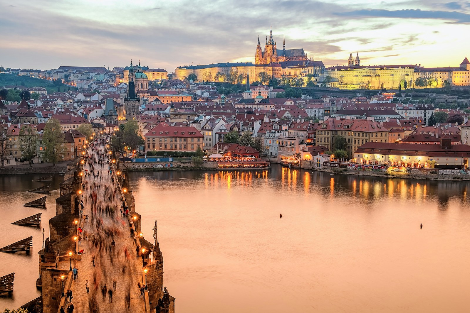 Charles Bridge and Prague Castle glowing at golden hour above the Vltava river