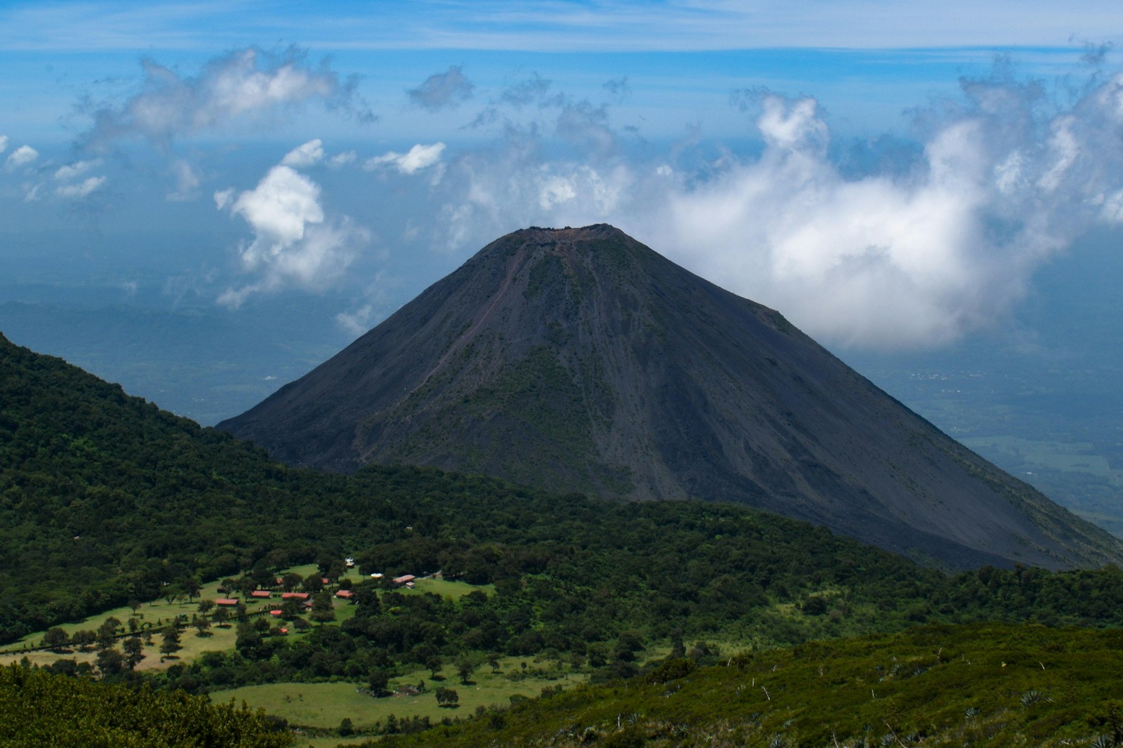 The perfect cone of the Izalco volcano rising above the green landscape in El Salvador