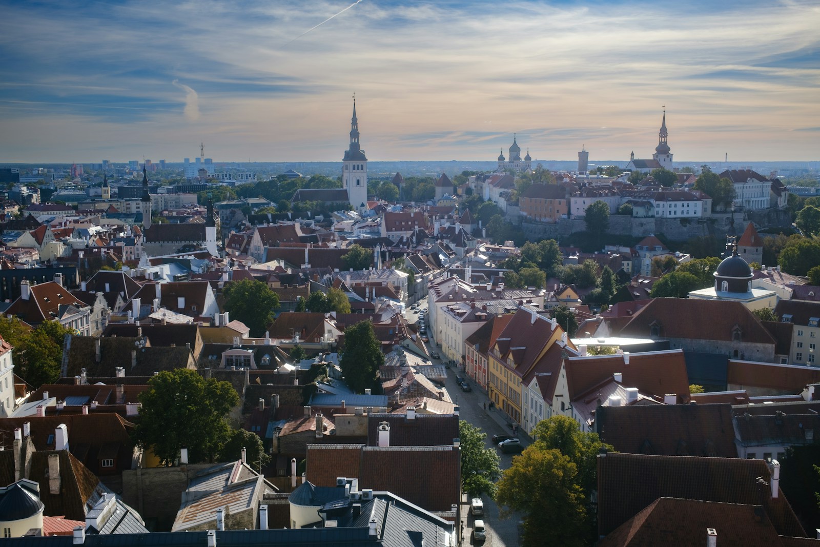 The red rooftops and church spires of Tallinn's medieval old town at golden hour