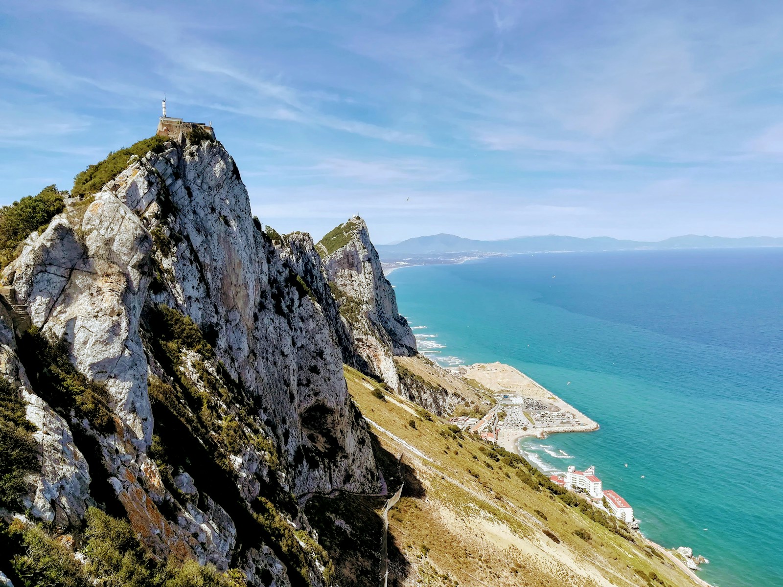 The limestone cliffs of the Rock of Gibraltar dropping to the turquoise Mediterranean