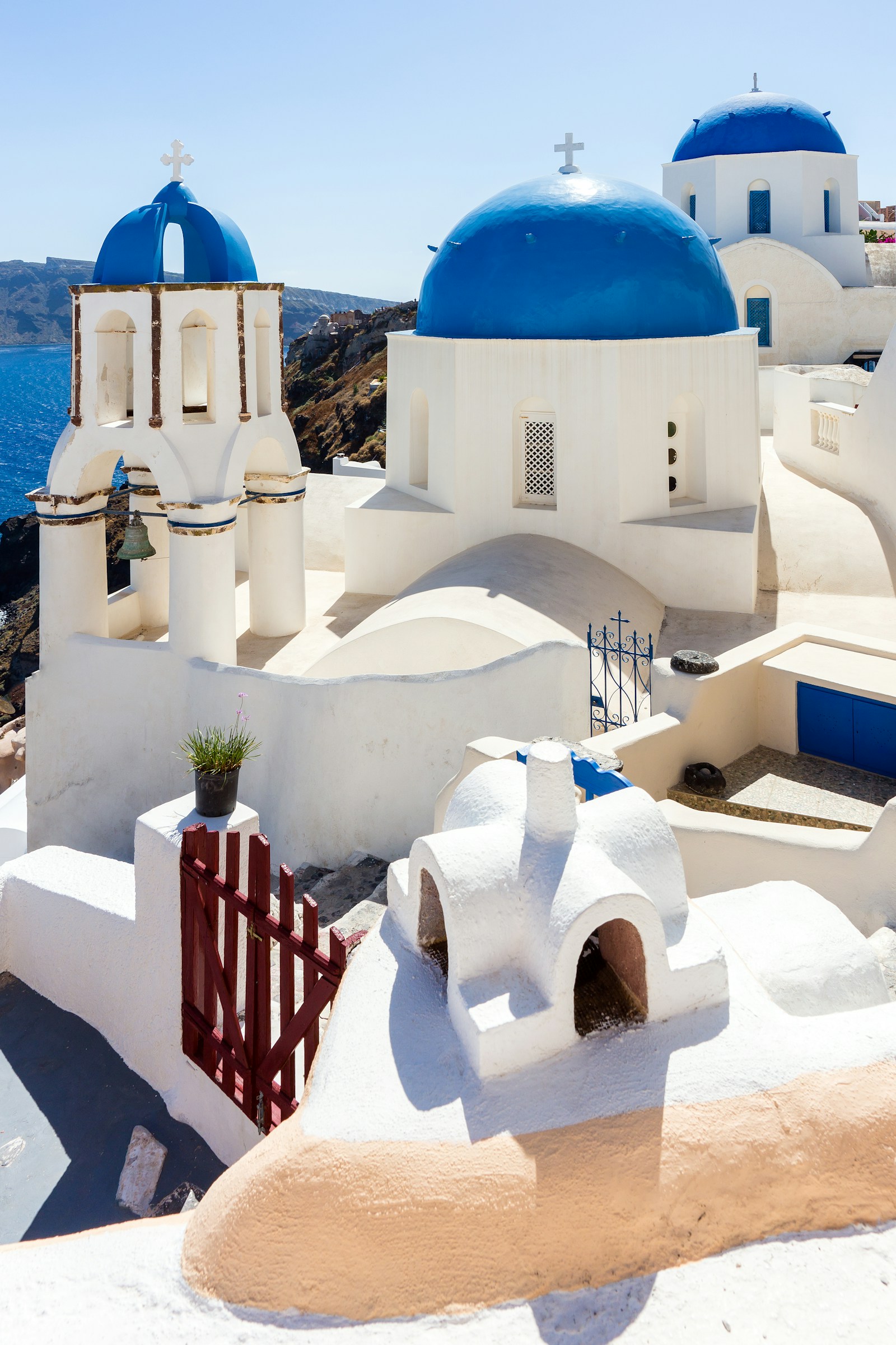 The blue-domed white churches of Oia above the Santorini caldera