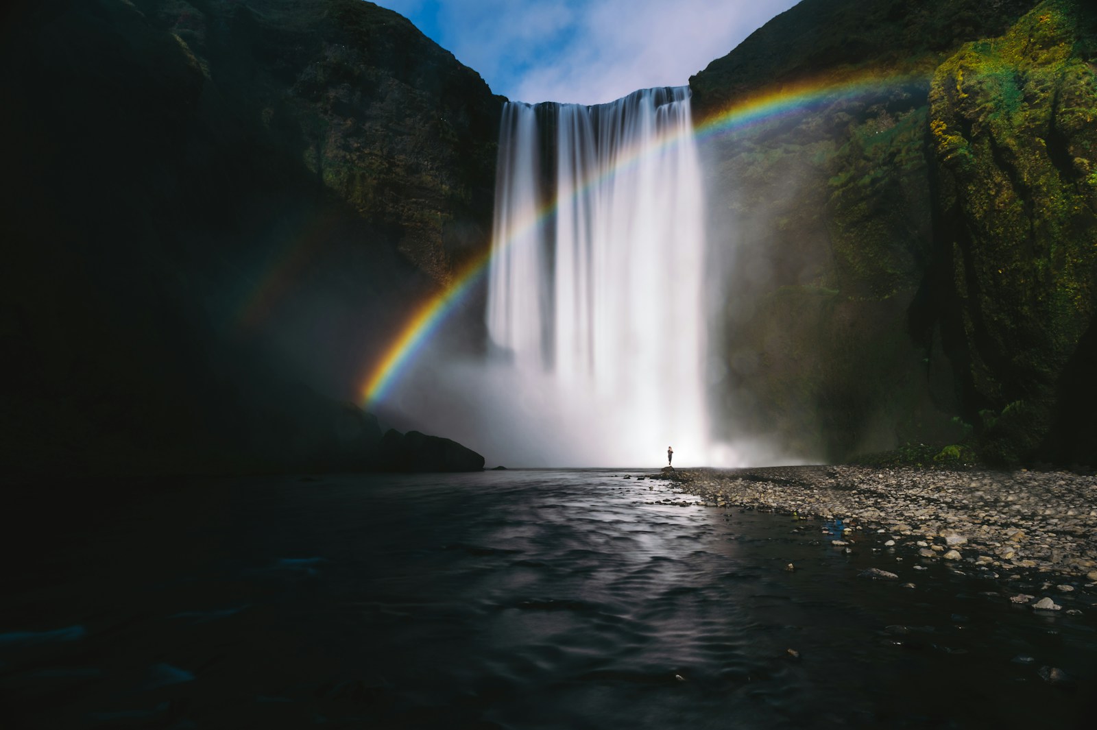 A rainbow arcing across the Skogafoss waterfall in Iceland