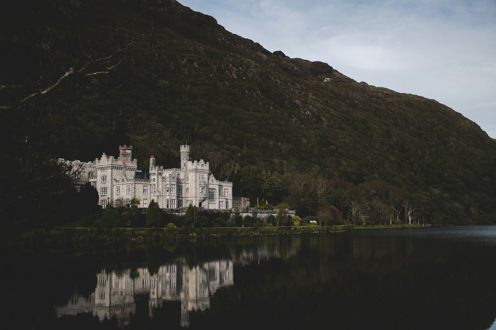 Kylemore Abbey reflected in its lake below a Connemara mountain
