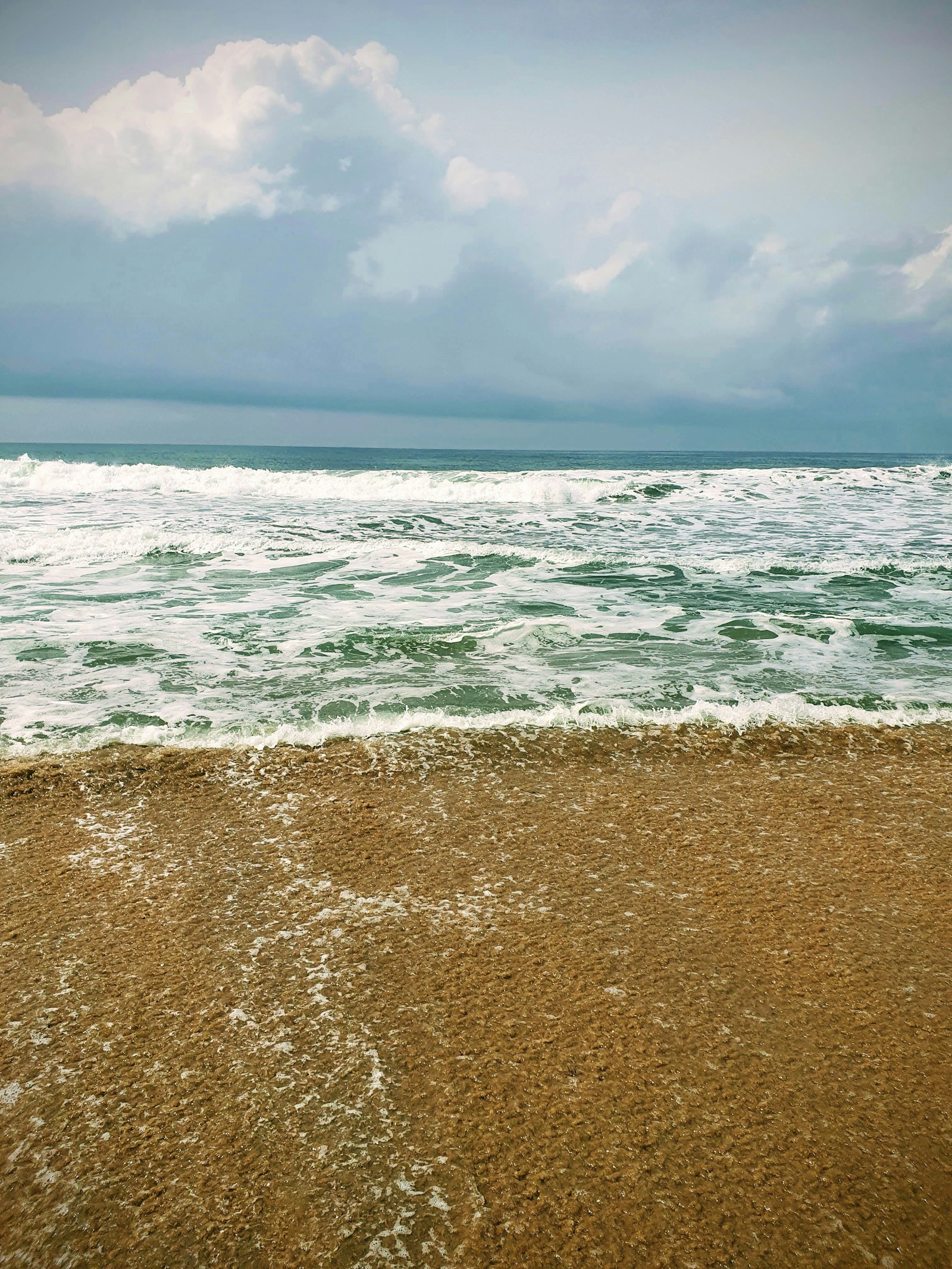 Waves rolling onto the sandy beach at Grand-Bassam, Ivory Coast