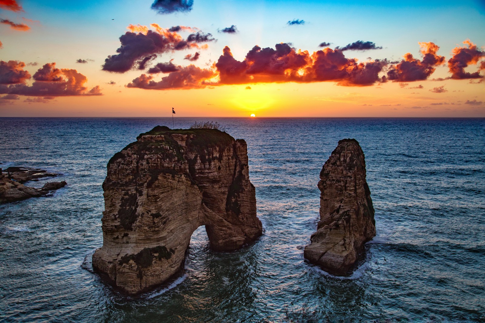 The Raouche Pigeon Rocks rising from the Mediterranean at sunset in Beirut, Lebanon