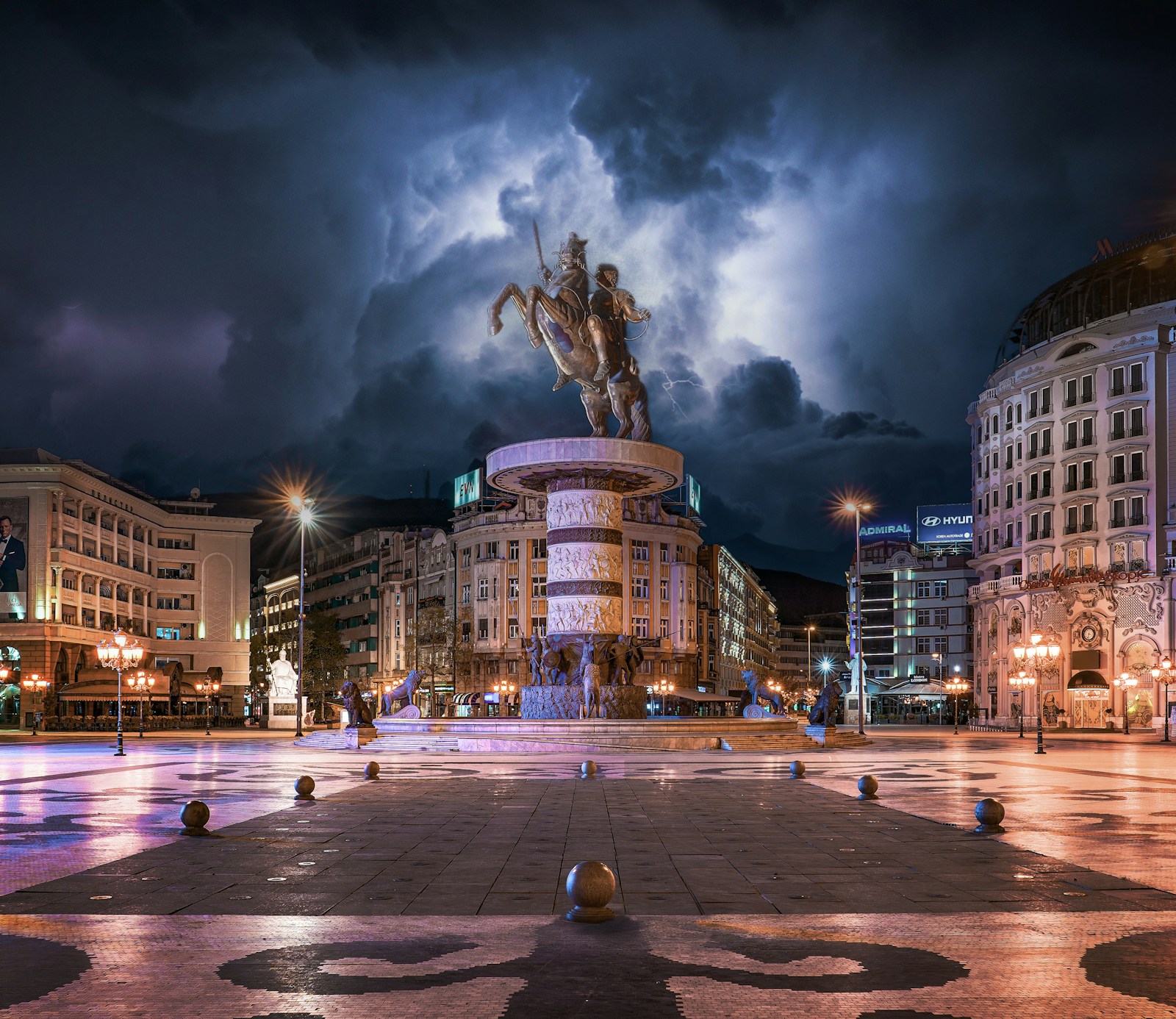 The Warrior on a Horse statue lit up in Macedonia Square in Skopje at night