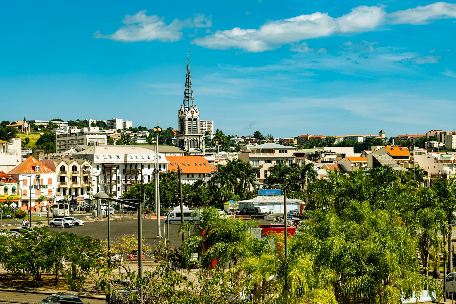 The town of Fort-de-France with its church spire and orange roofs below green hills, Martinique