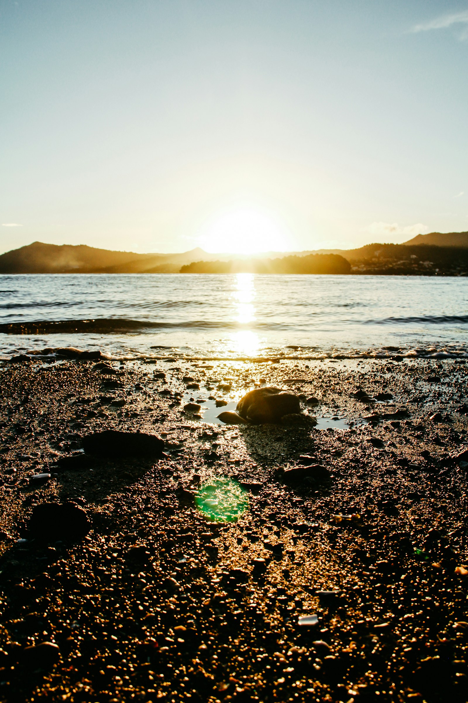 Golden sunset over the lagoon with the island's hills silhouetted, Dzaoudzi, Mayotte