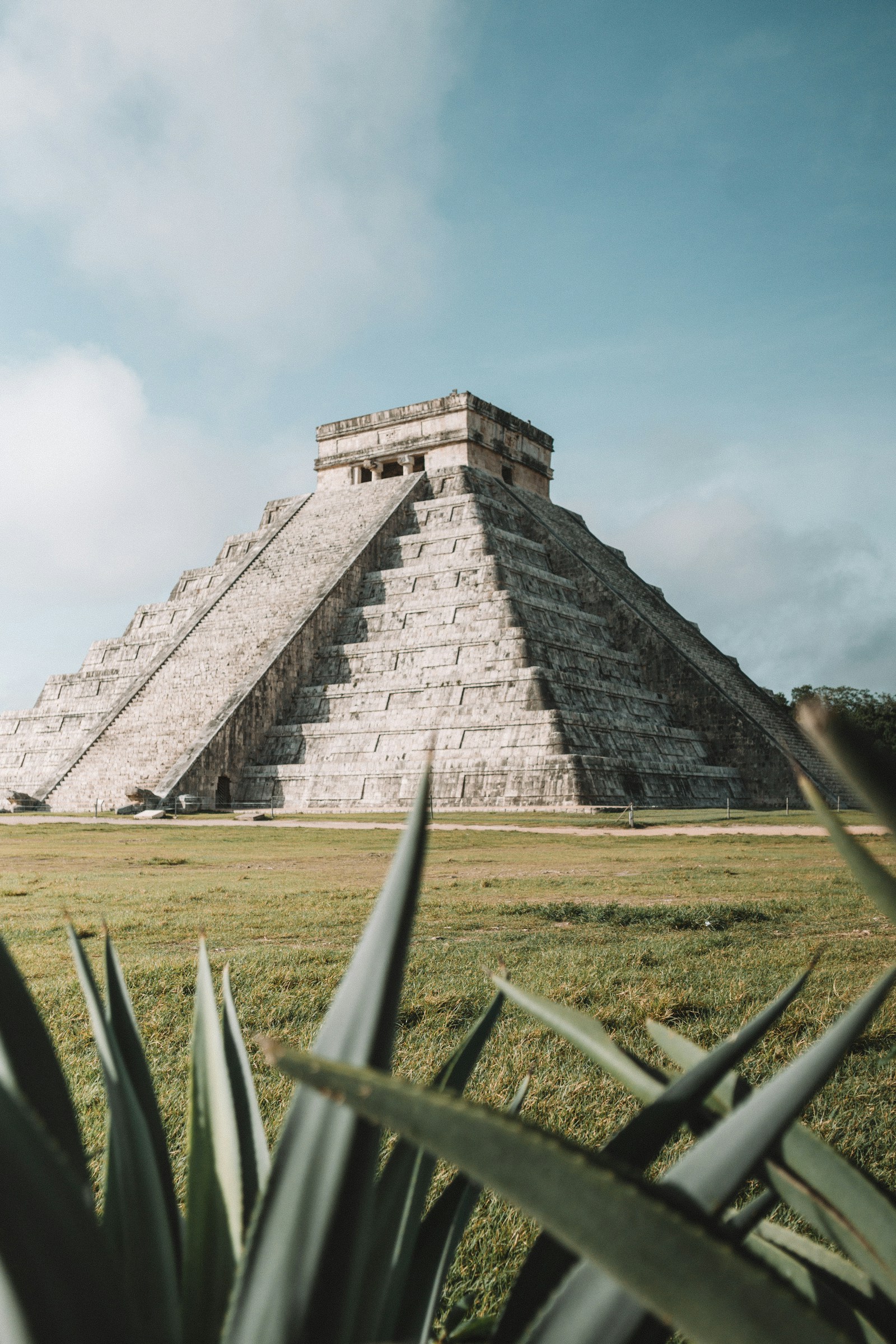 El Castillo, the Kukulcan pyramid at Chichen Itza, framed by agave