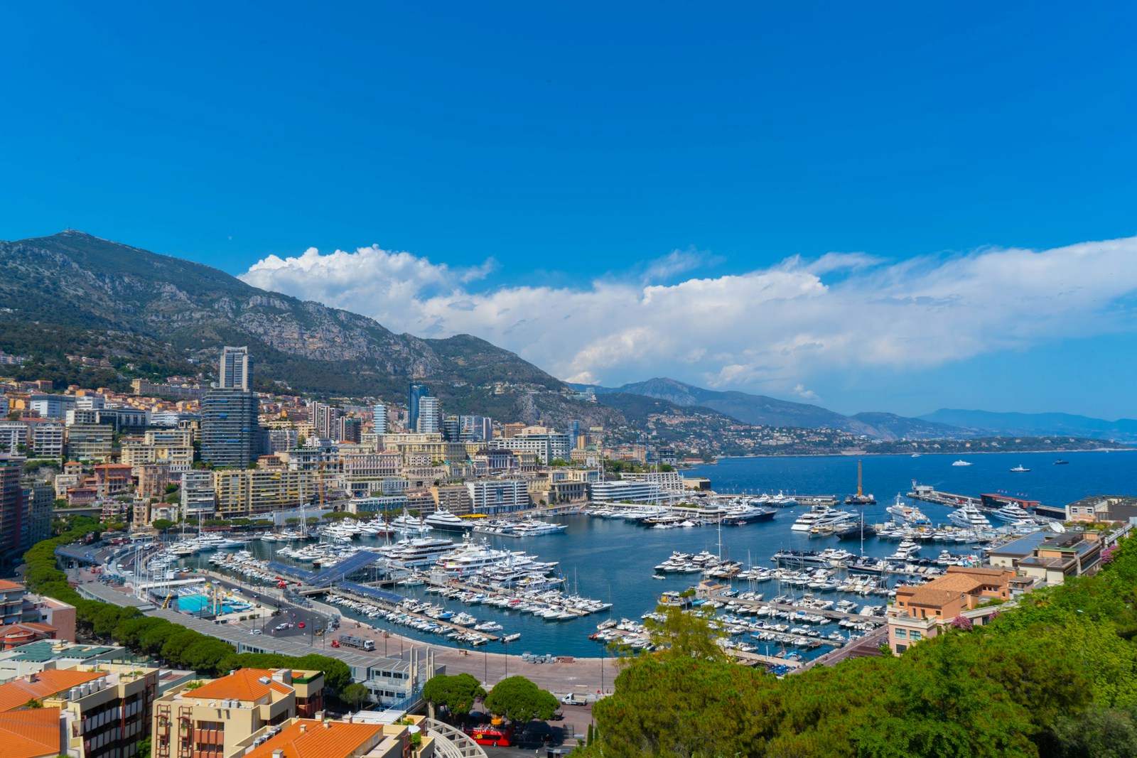 Port Hercule packed with superyachts below the Monte Carlo skyline and mountains, Monaco