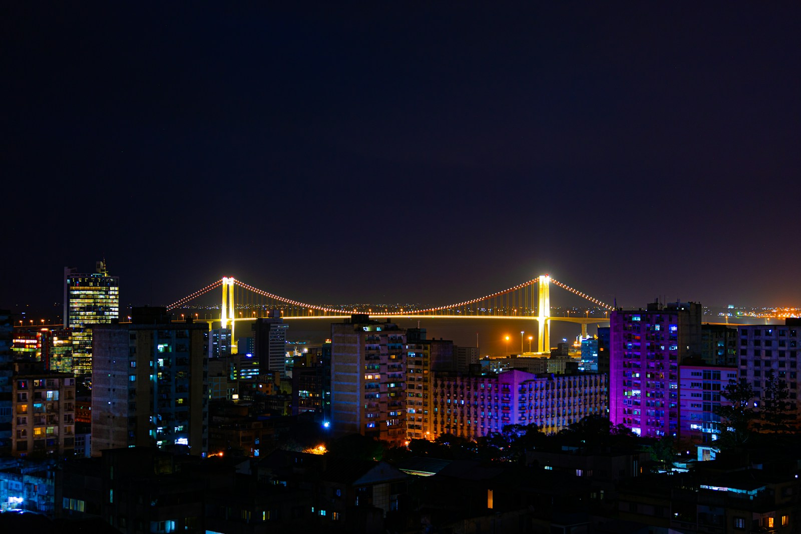 The Maputo skyline at night with the lit Maputo-Katembe suspension bridge, Mozambique