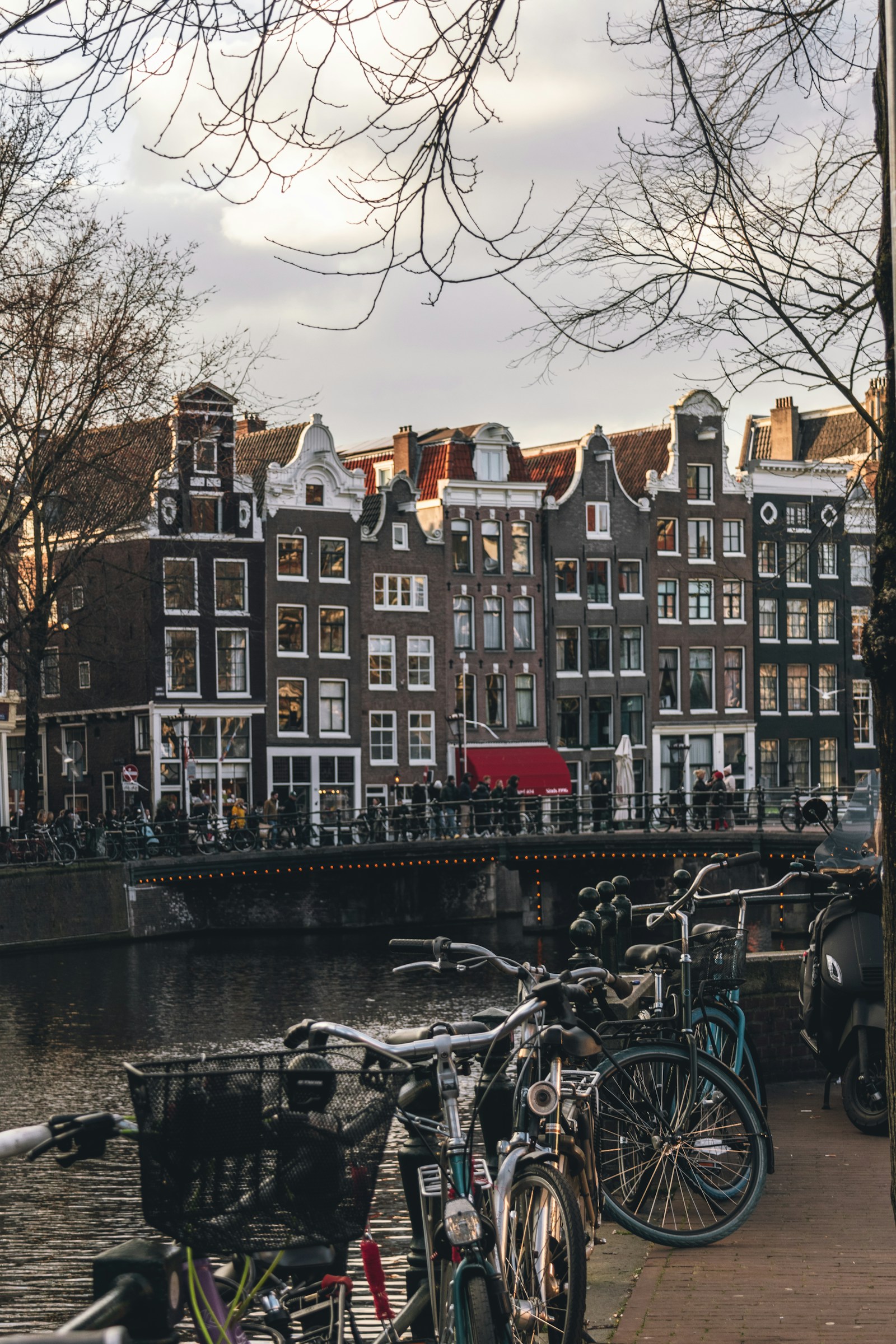 Bikes by a canal lined with historic gabled houses in Amsterdam
