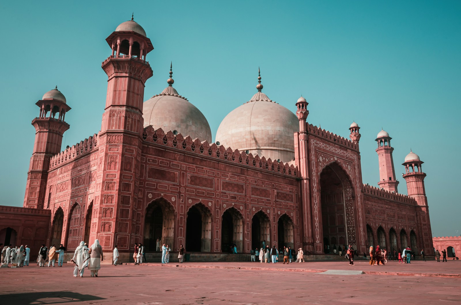 The red sandstone walls and white marble domes of the Badshahi Mosque in Lahore, Pakistan