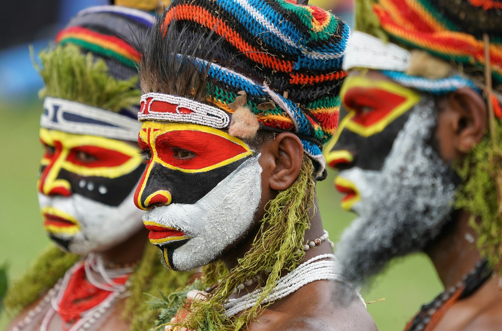 Performers in vivid face paint at a Sing Sing tribal dance, Papua New Guinea