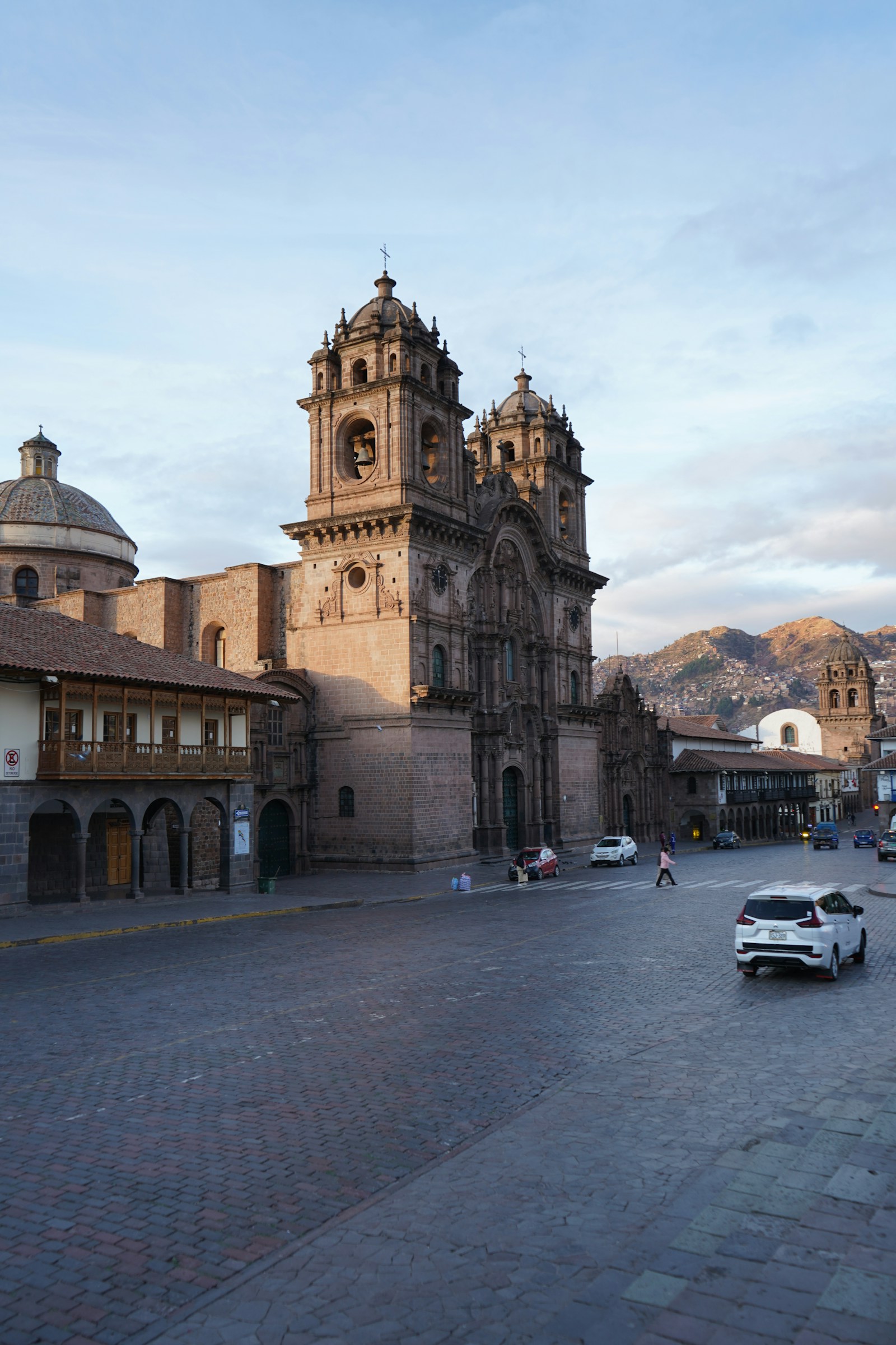 A baroque church on the Plaza de Armas in Cusco, with the Andean city behind