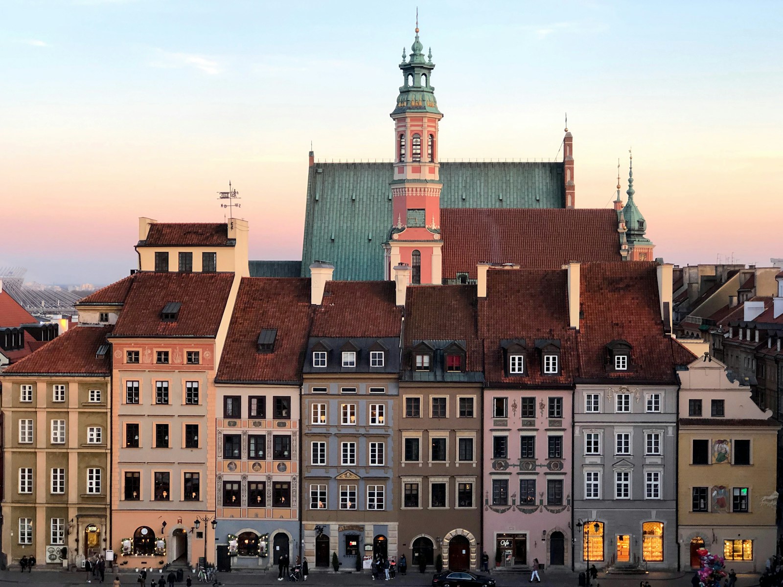 The colourful rebuilt merchant houses of Warsaw's Old Town Market Square at sunset