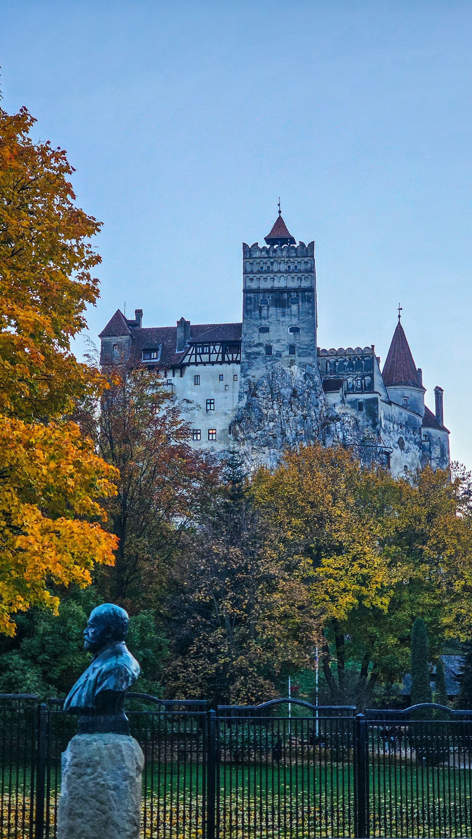 Bran Castle, the gothic Dracula castle, on its crag framed by autumn foliage in Transylvania