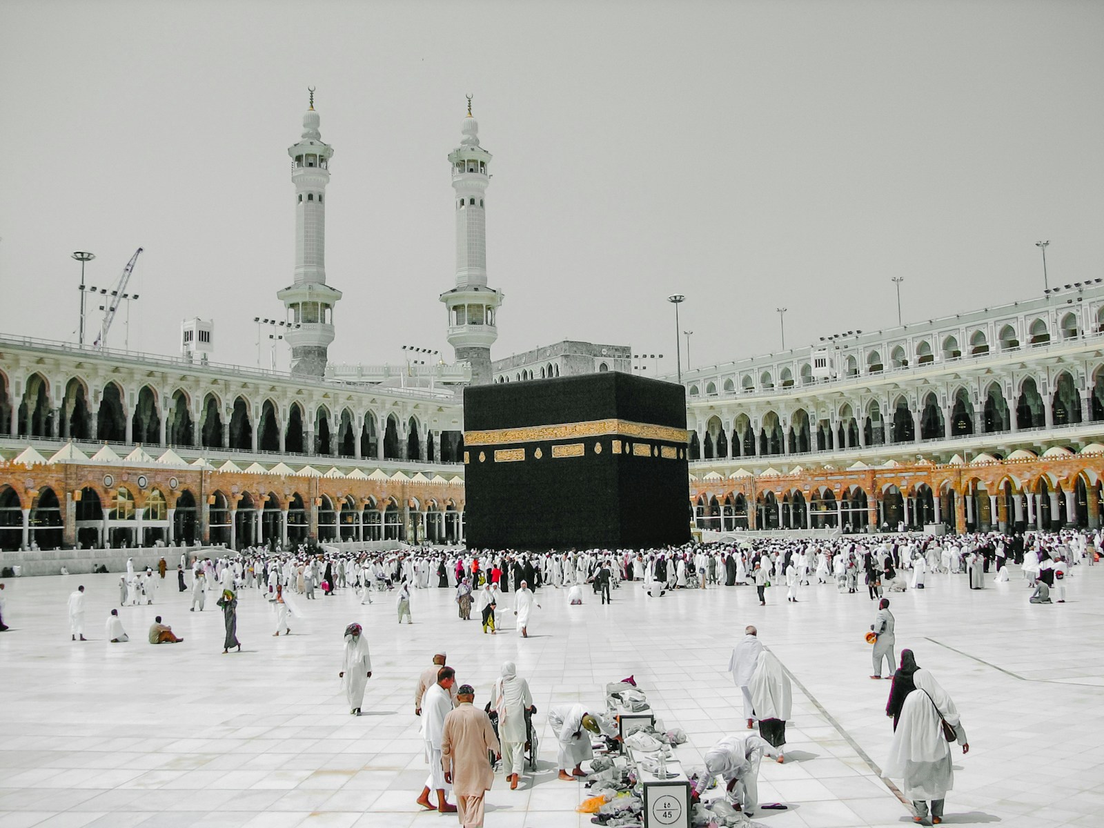 Pilgrims in the courtyard of the Masjid al-Haram around the Kaaba in Mecca