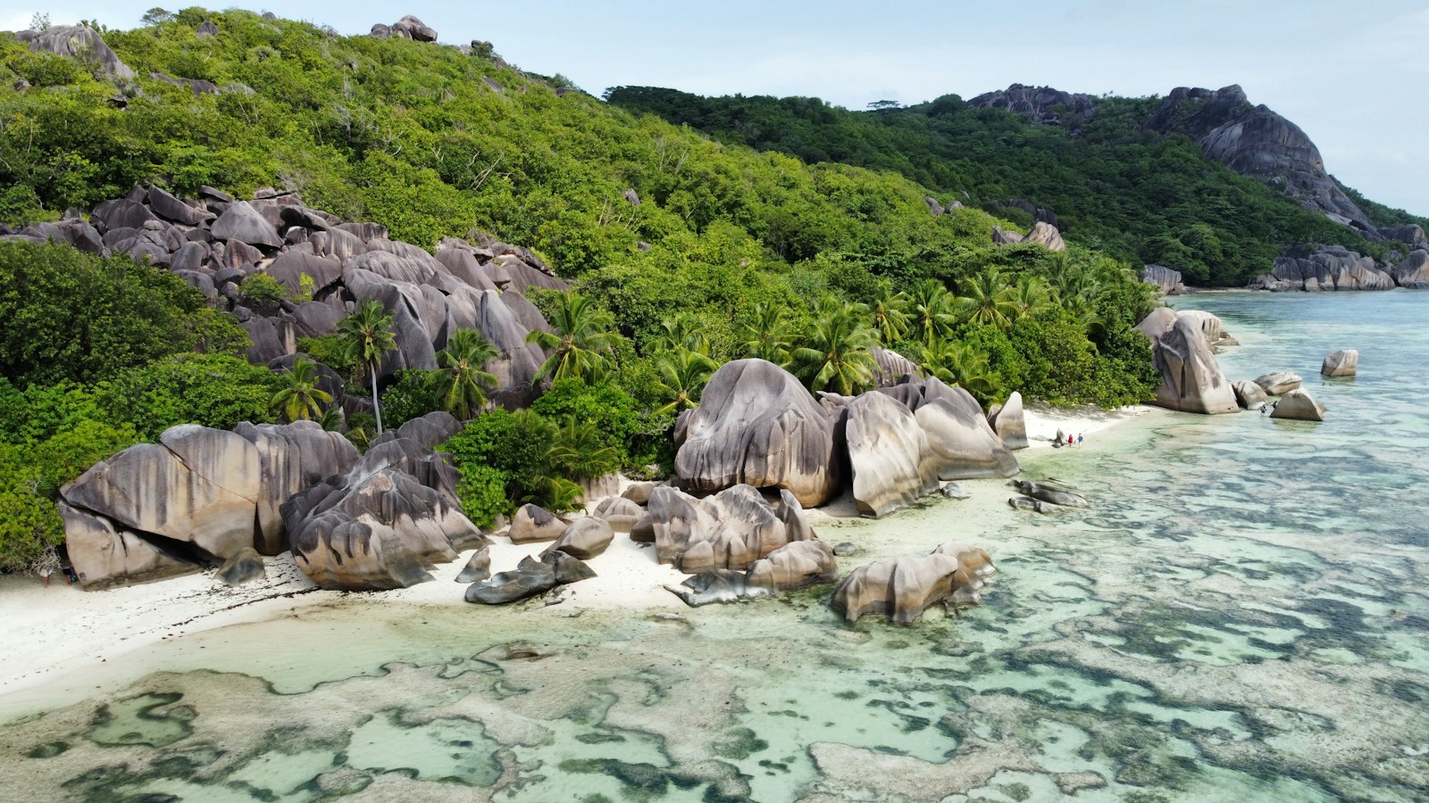 An aerial view of the sculpted granite boulders and turquoise water of Anse Source d'Argent, La Digue, Seychelles