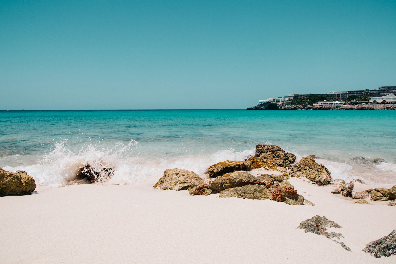 Calm turquoise water and rocks on Maho Beach, Sint Maarten