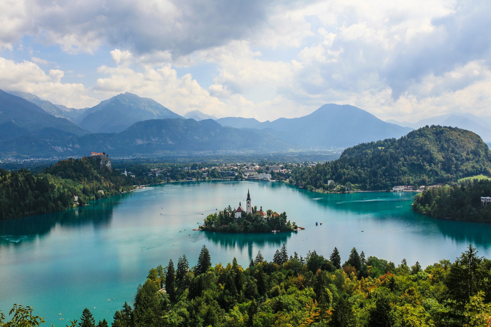 The island church of Lake Bled with Bled Castle and the Julian Alps behind