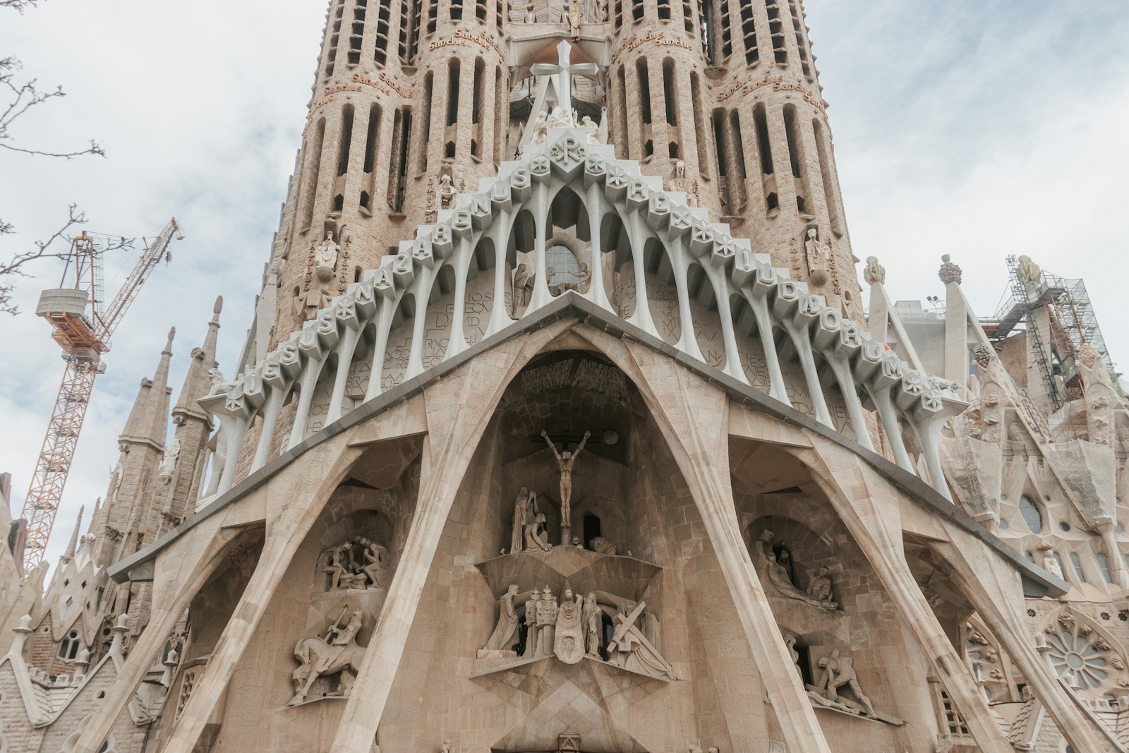 The Passion facade of the Sagrada Familia rising against the Barcelona sky