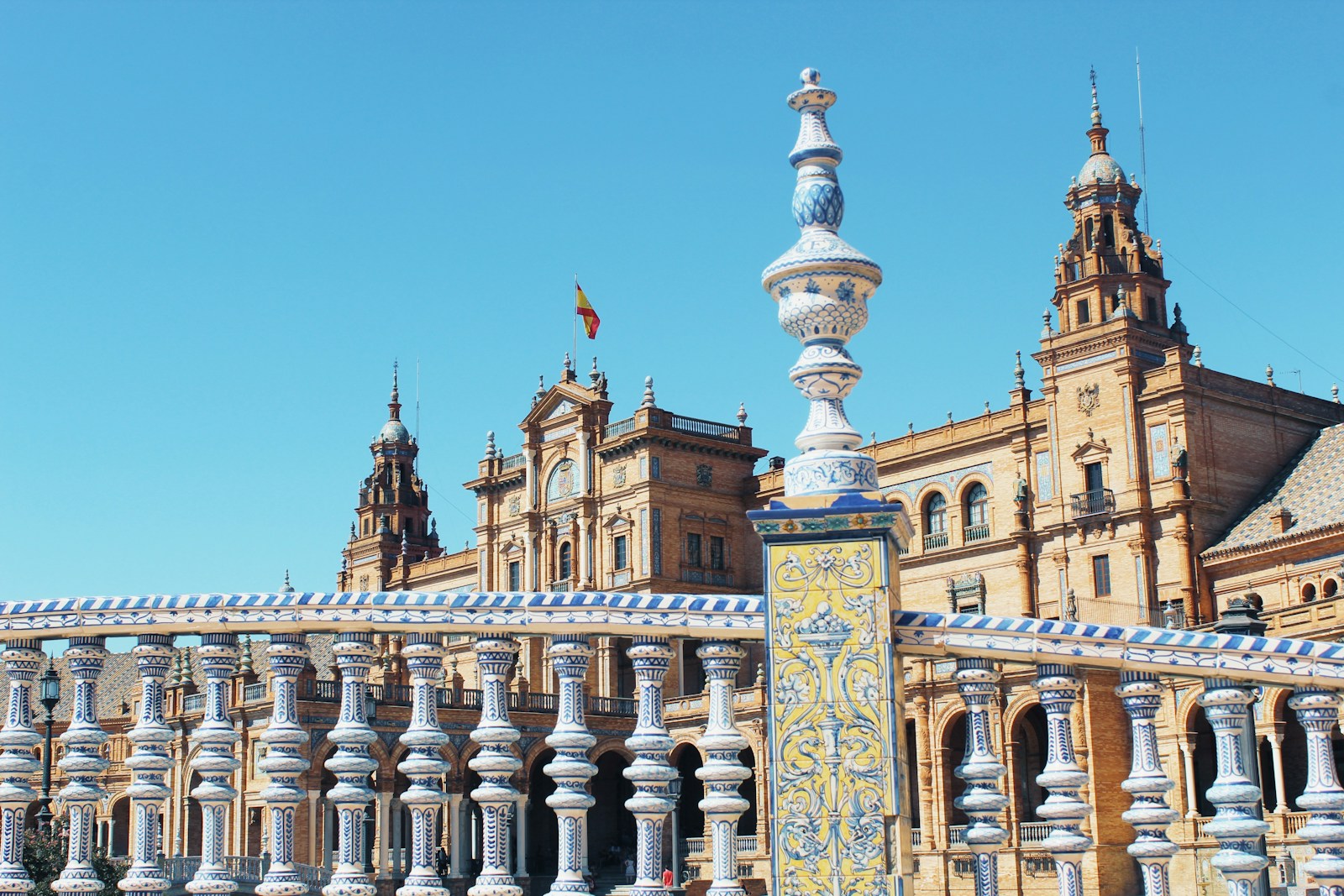 The ceramic balustrades and brick towers of the Plaza de Espana in Seville