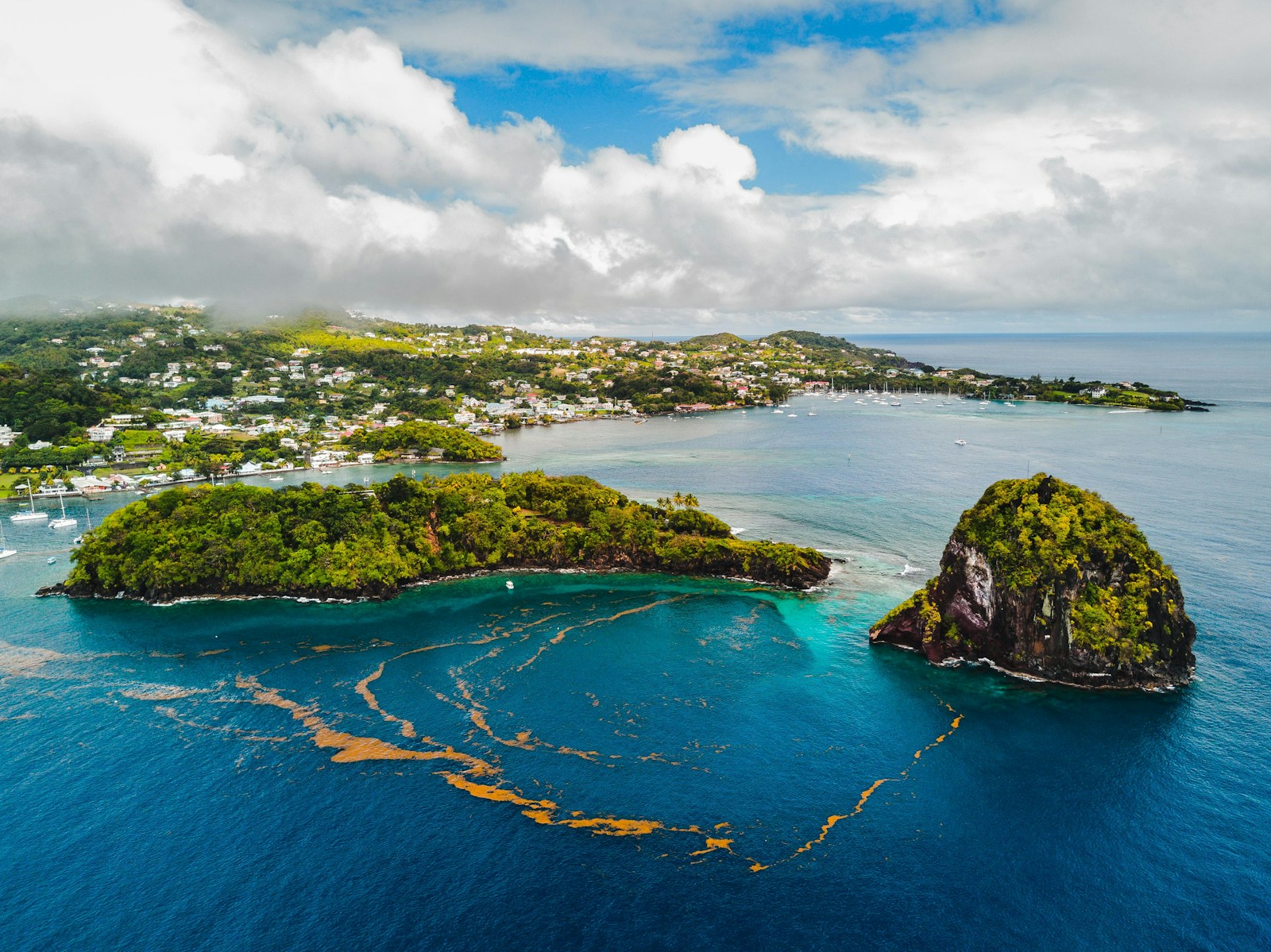 Aerial of Young Island and the south coast of St Vincent with a rock islet