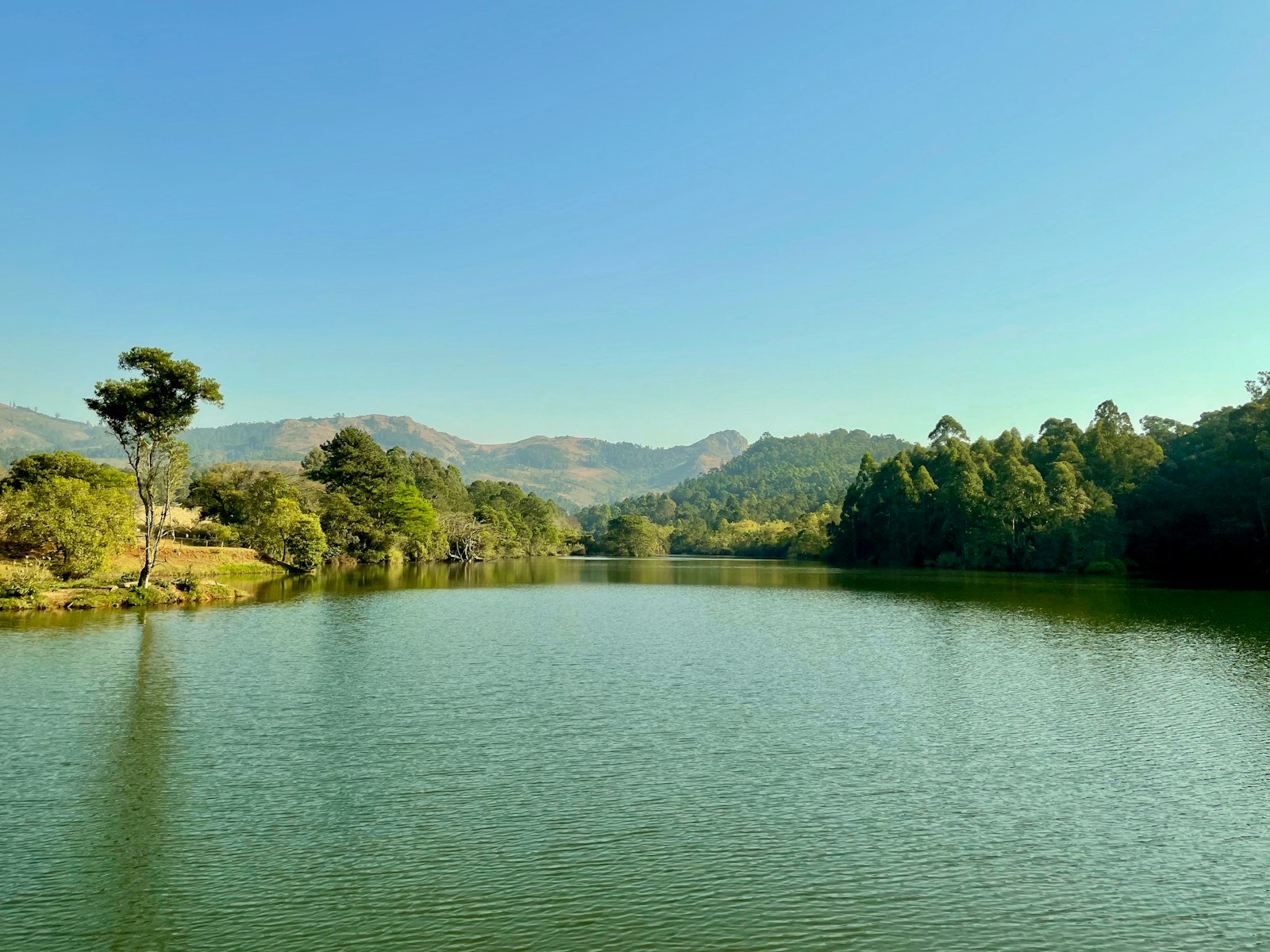 A calm lake and green hills at Mlilwane Wildlife Sanctuary, Lobamba, Eswatini